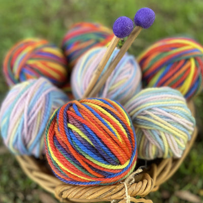 A basket filled with 16ply multicoloured Wool Yarn