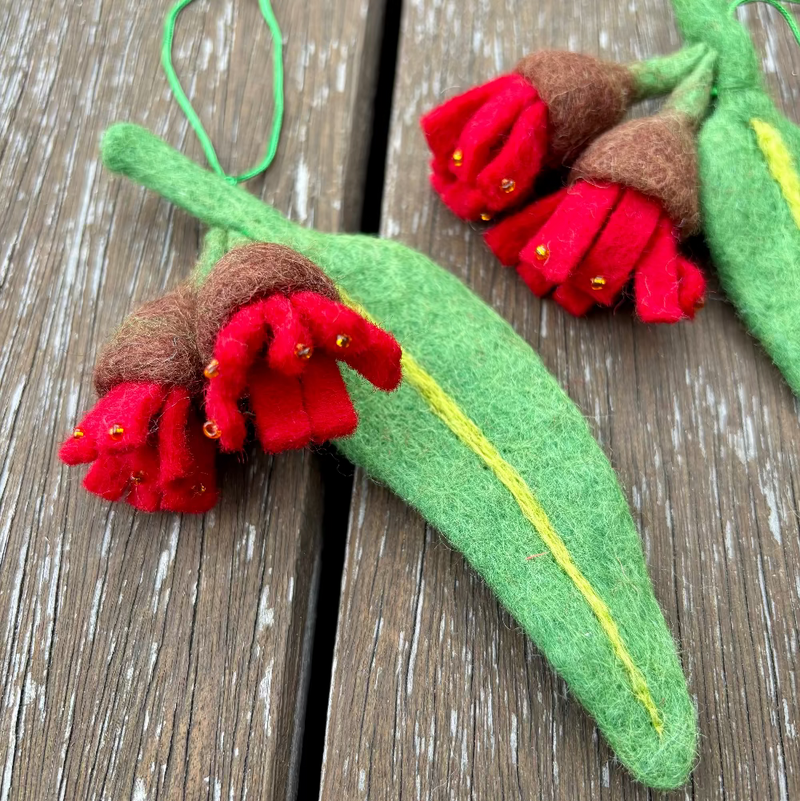 Felted native gum flower decorations on a wooden surface
