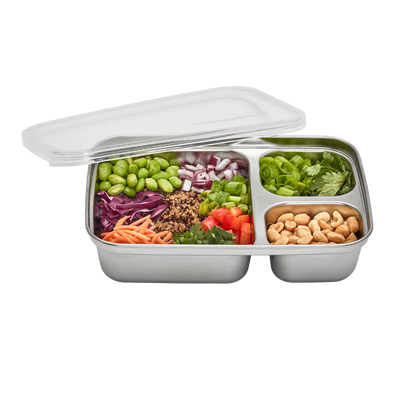 Stainless steel 3 compartment food container with silicone lid showing a variety of vegetables and nuts.