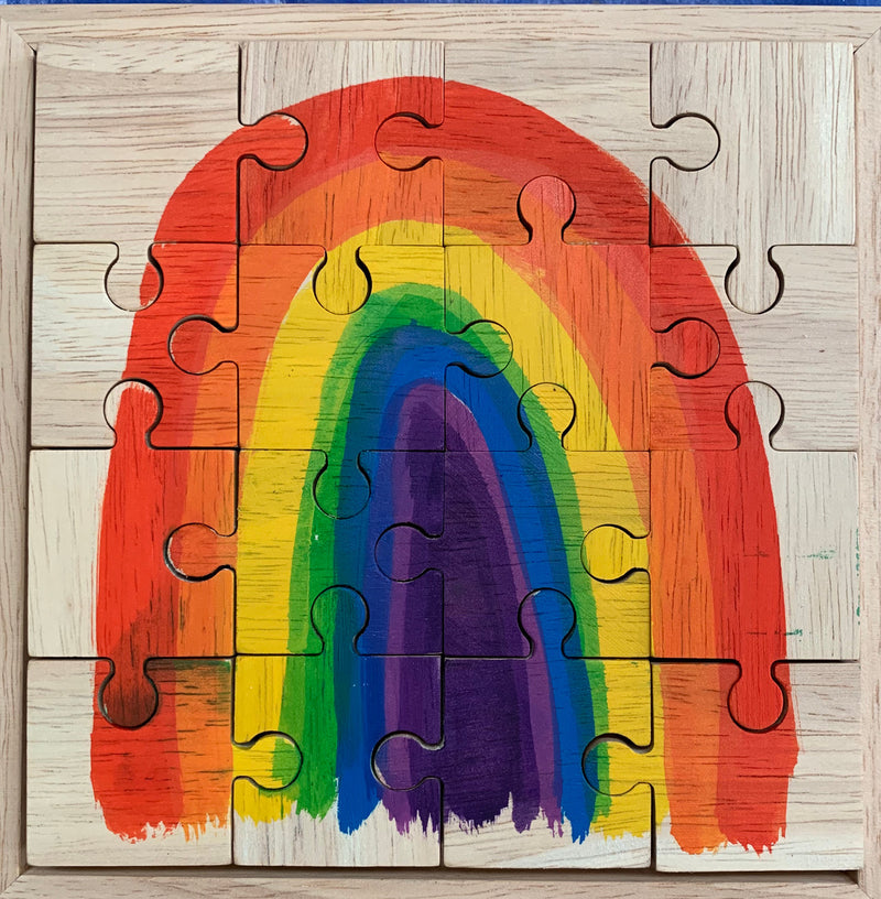 Wooden puzzle with a colorful rainbow design on a wooden frame
