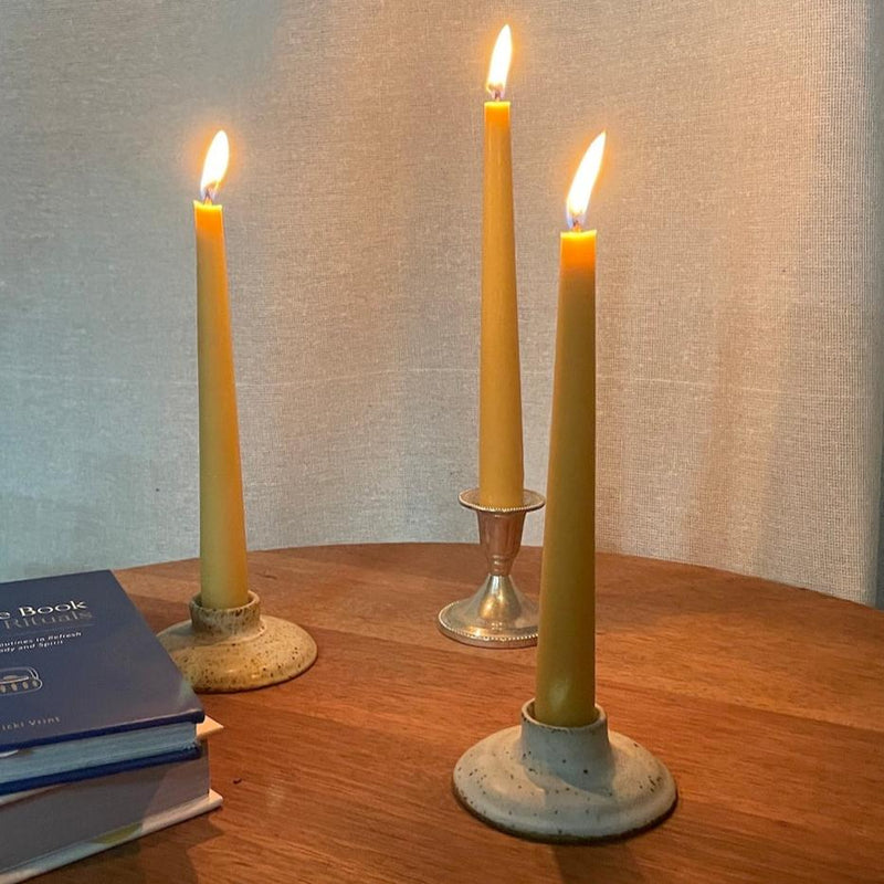 Happy Flame Tapered Candles burning in candle holders